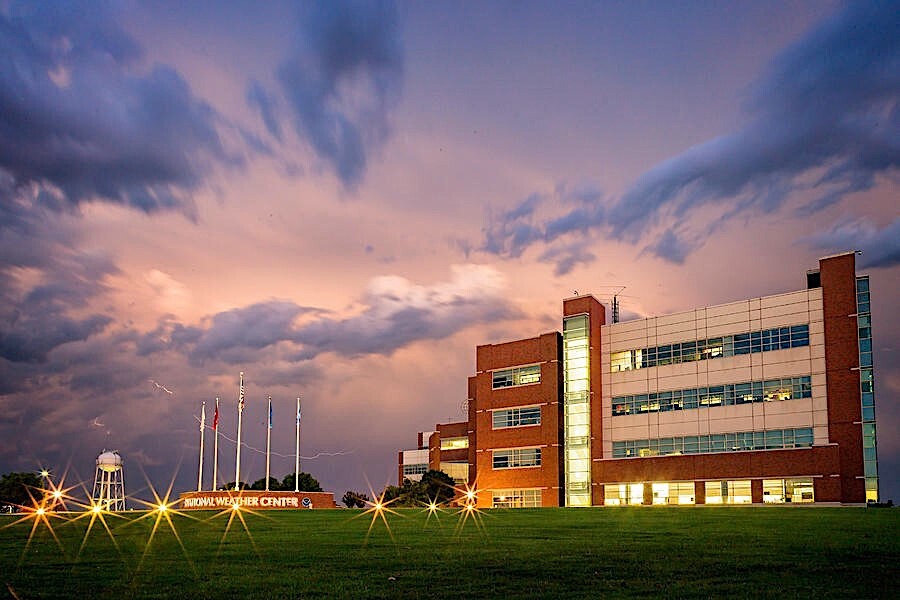 The National Weather Center, with purple and pink storm clouds in the background.