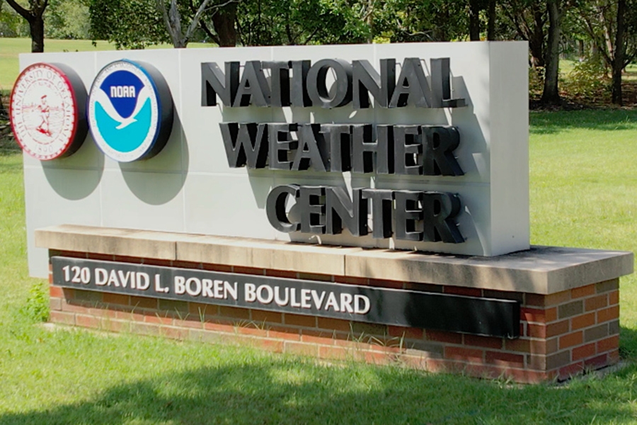 The National Weather Center sign, with the seals of O U and N O A A and the street address of 120 David. L. Boren Boulevard.