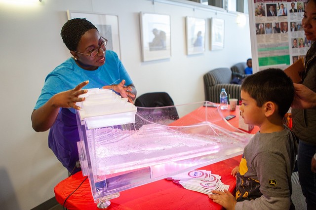 A National Weather Festival attendee learns about a hydrological model from a CASS employee.