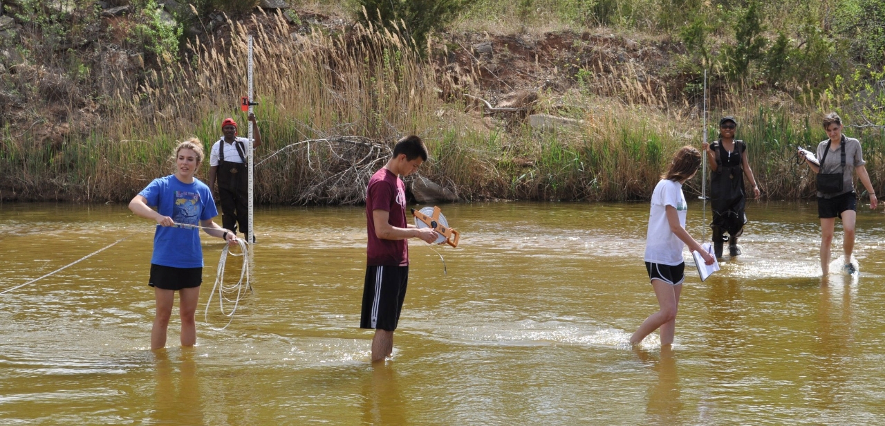 DGES students perform research in the Canadian River in Cleveland County, Oklahoma. (Image courtesy: Department of Geography and Environmental Sustainability Facebook)