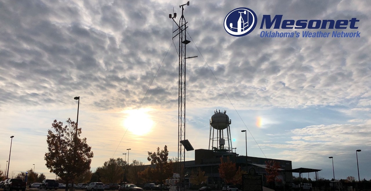 The Oklahoma Mesonet Tower located at the National Weather Center, flanked by sundog and the Sun. Mesonet, Oklahoma's Weather Network.