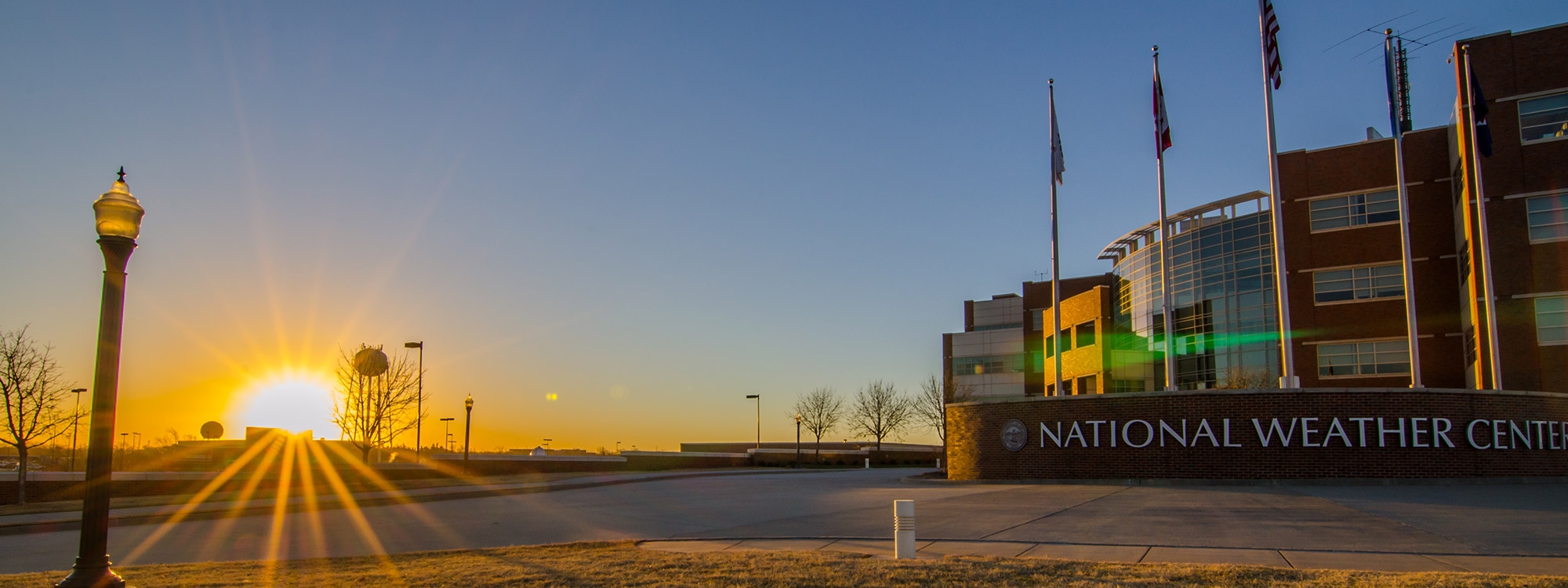 The National Weather Center with a sunrise in the background.