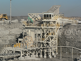 Mine haul trucks dump the blasted stone into the primary crusher where rock is reduced further in size.