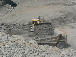 Figure 1. Blasted rock is loaded at the quarry bench into giant mine haul trucks.