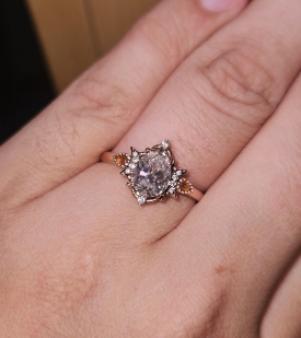 Engagement ring pictured on someone's finger