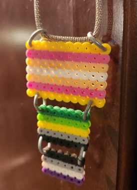 Homemade beaded necklace of the pangender, aromantic, and asexual flags. 