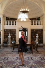 Abbey Sempebwa posing in front of a painting