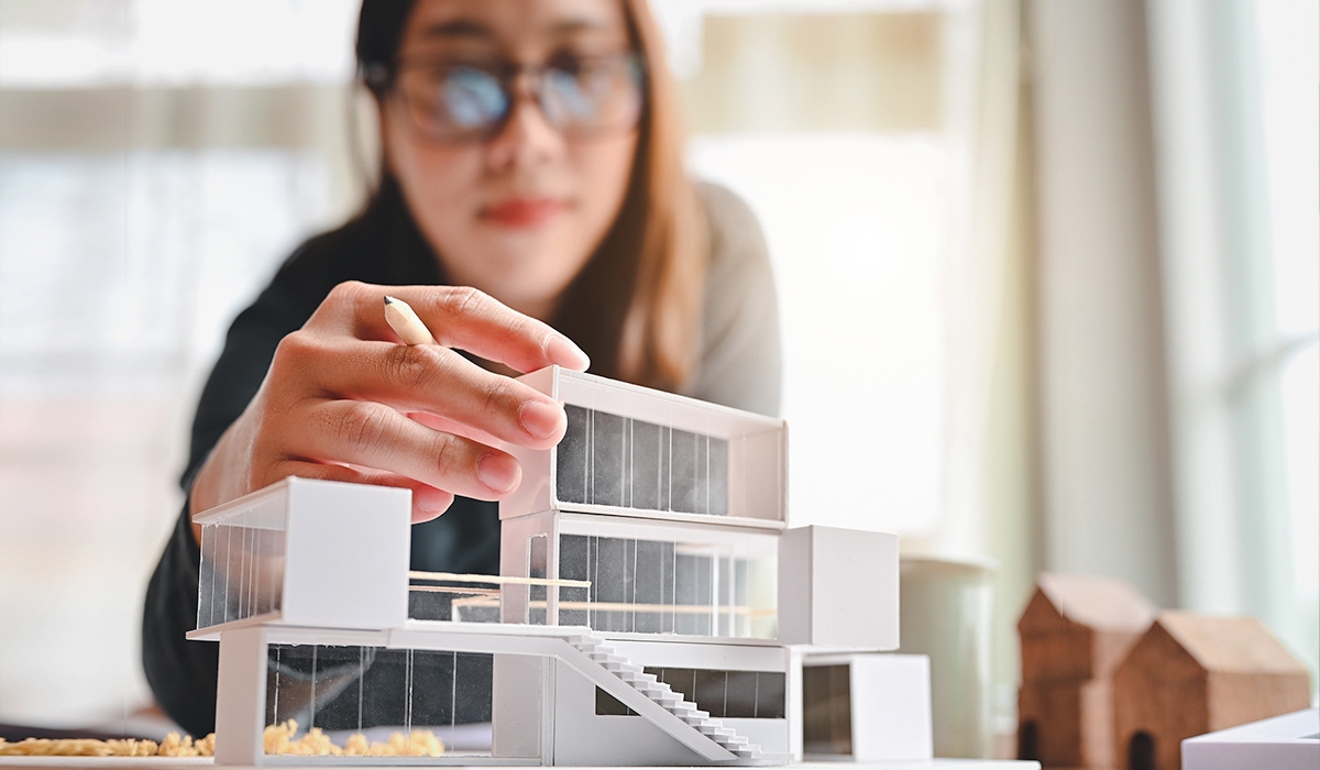 architect putting a 3-d building model together