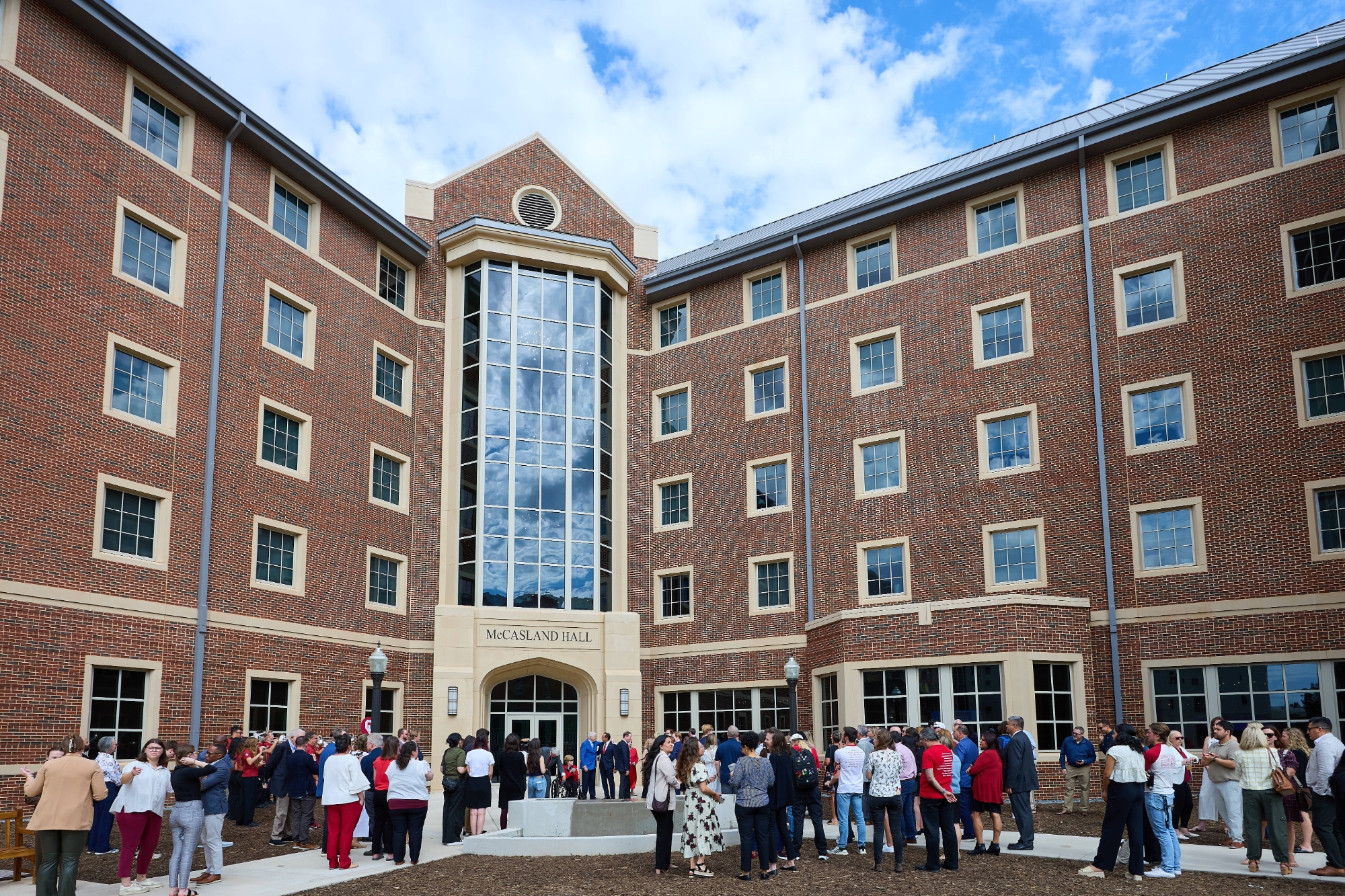 Exterior of McCasland Hall with people outside.