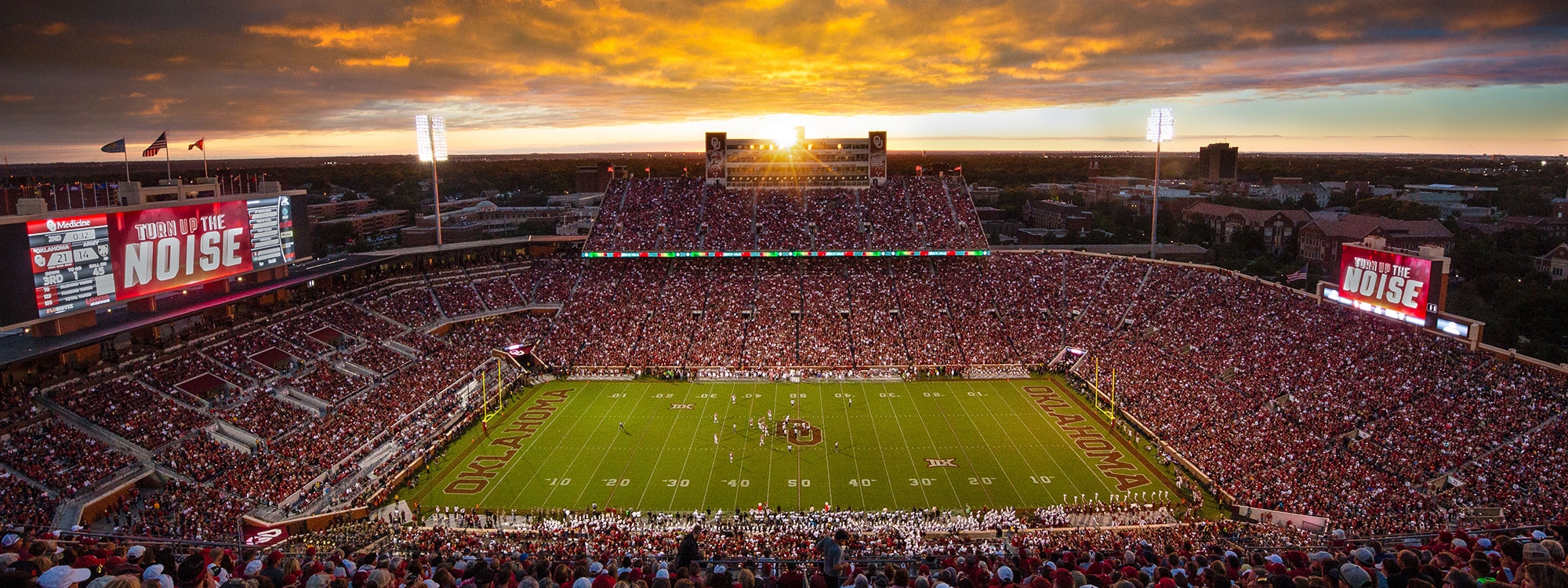 Gaylord Family Oklahoma Memorial Stadium with a sunset in the background.