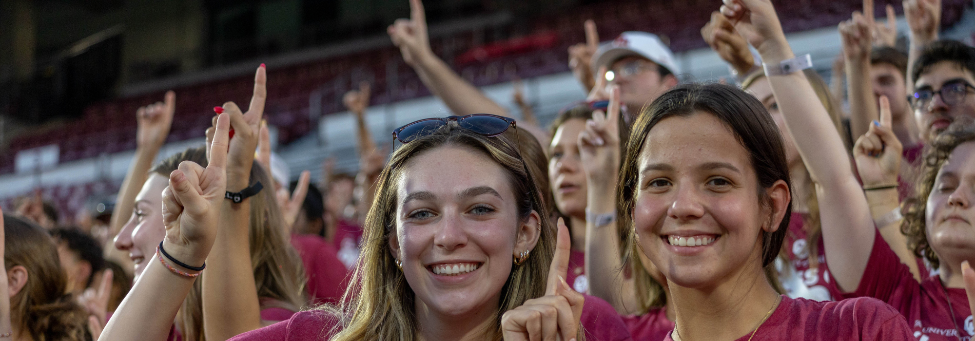 Small group leader high-fiving campers during Camp Crimson opening session.