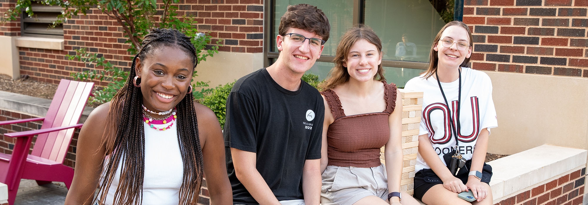 Students sitting outside of Cross residence hall.