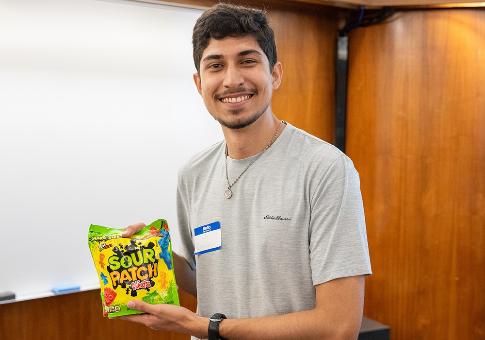 Students holding a bag of candy he won at the OU Cousins Bingo event.