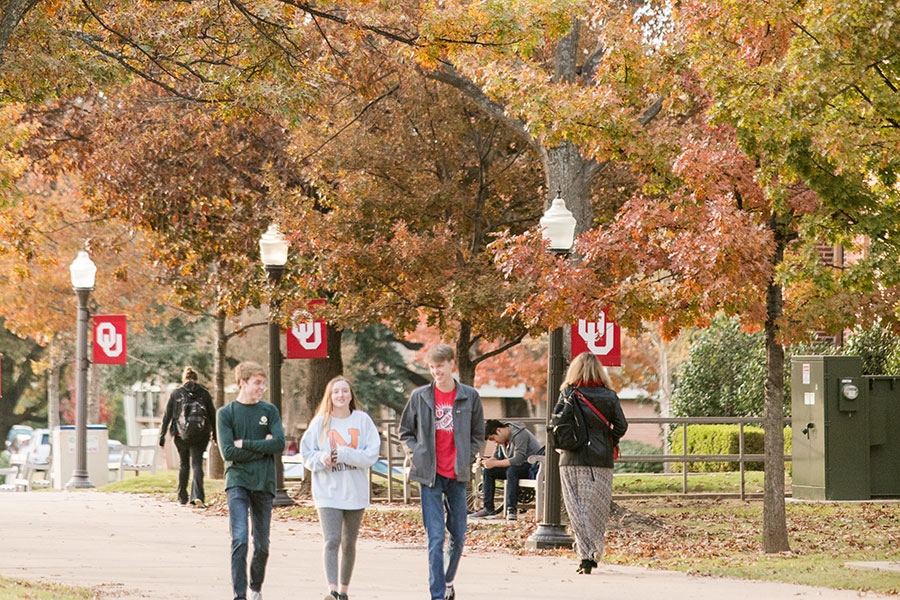 Students walking on campus during the fall.
