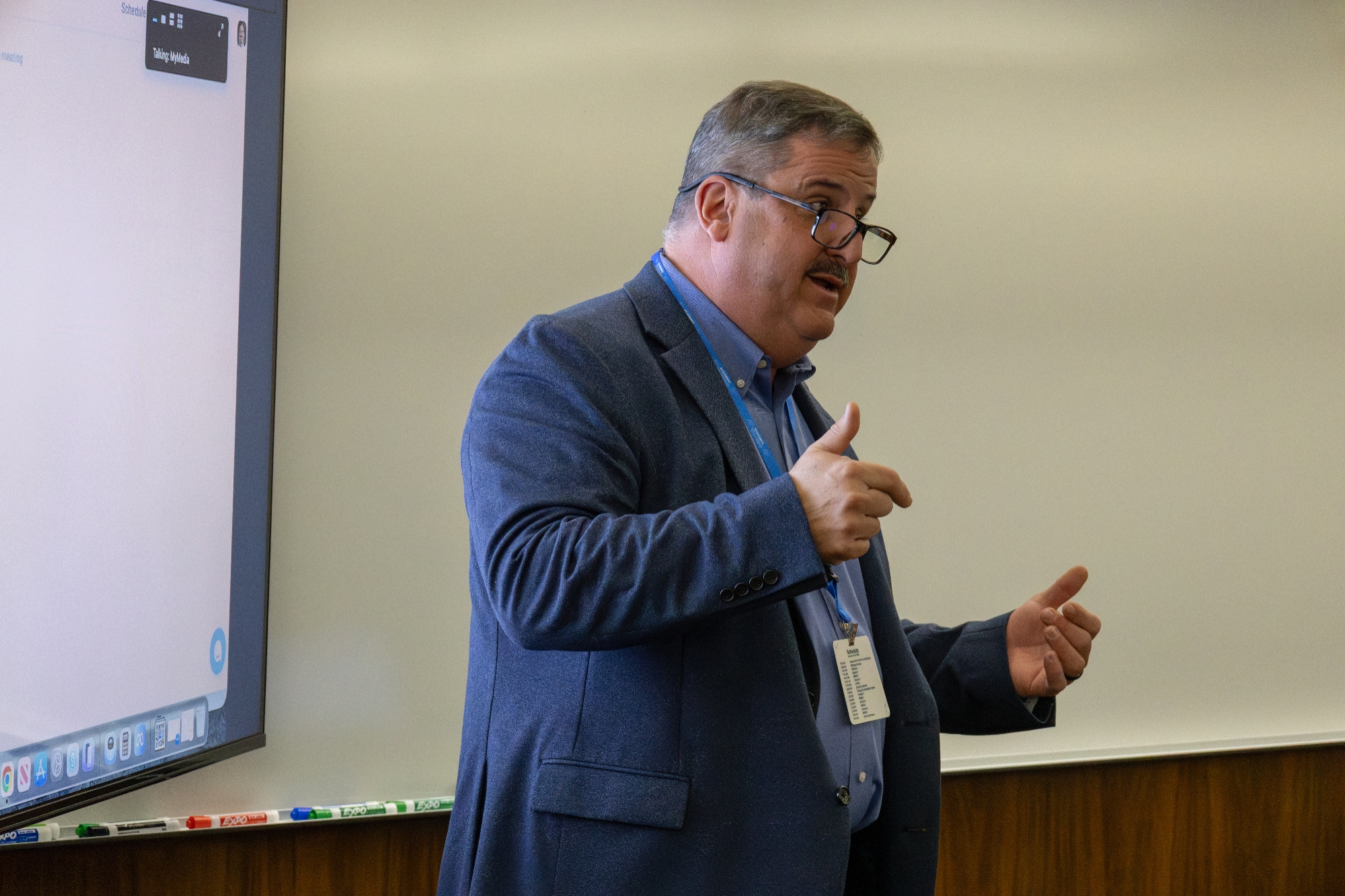 Person wearing glasses talking.