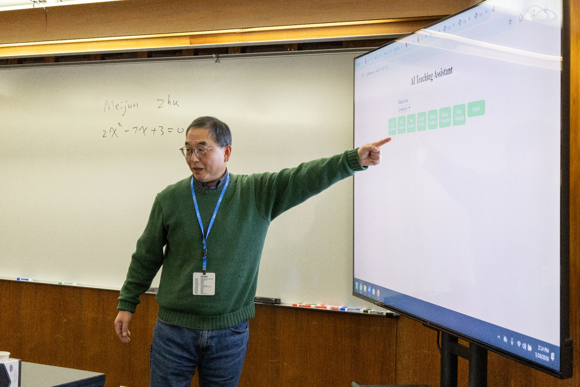A person speaking and pointing at a slide on a tv.