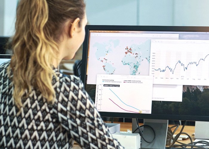 Young woman viewing viewing location maps on her computer