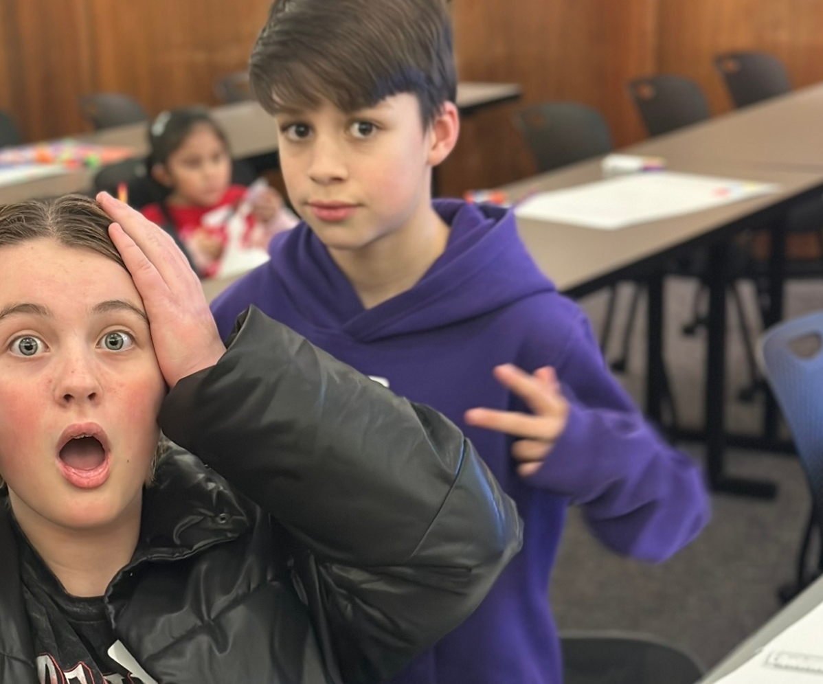 students standing outside with staff by a truck