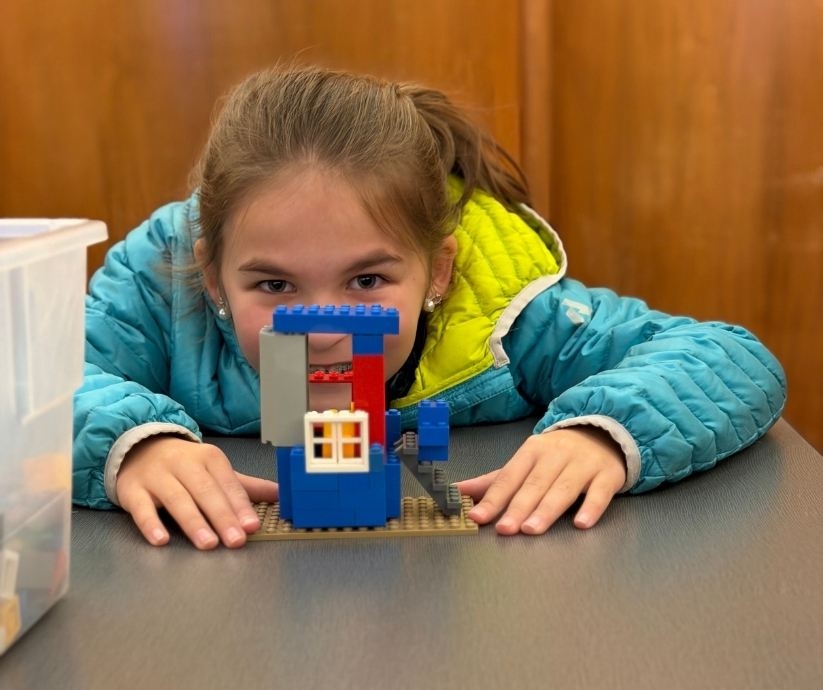 students standing outside with staff by a truck