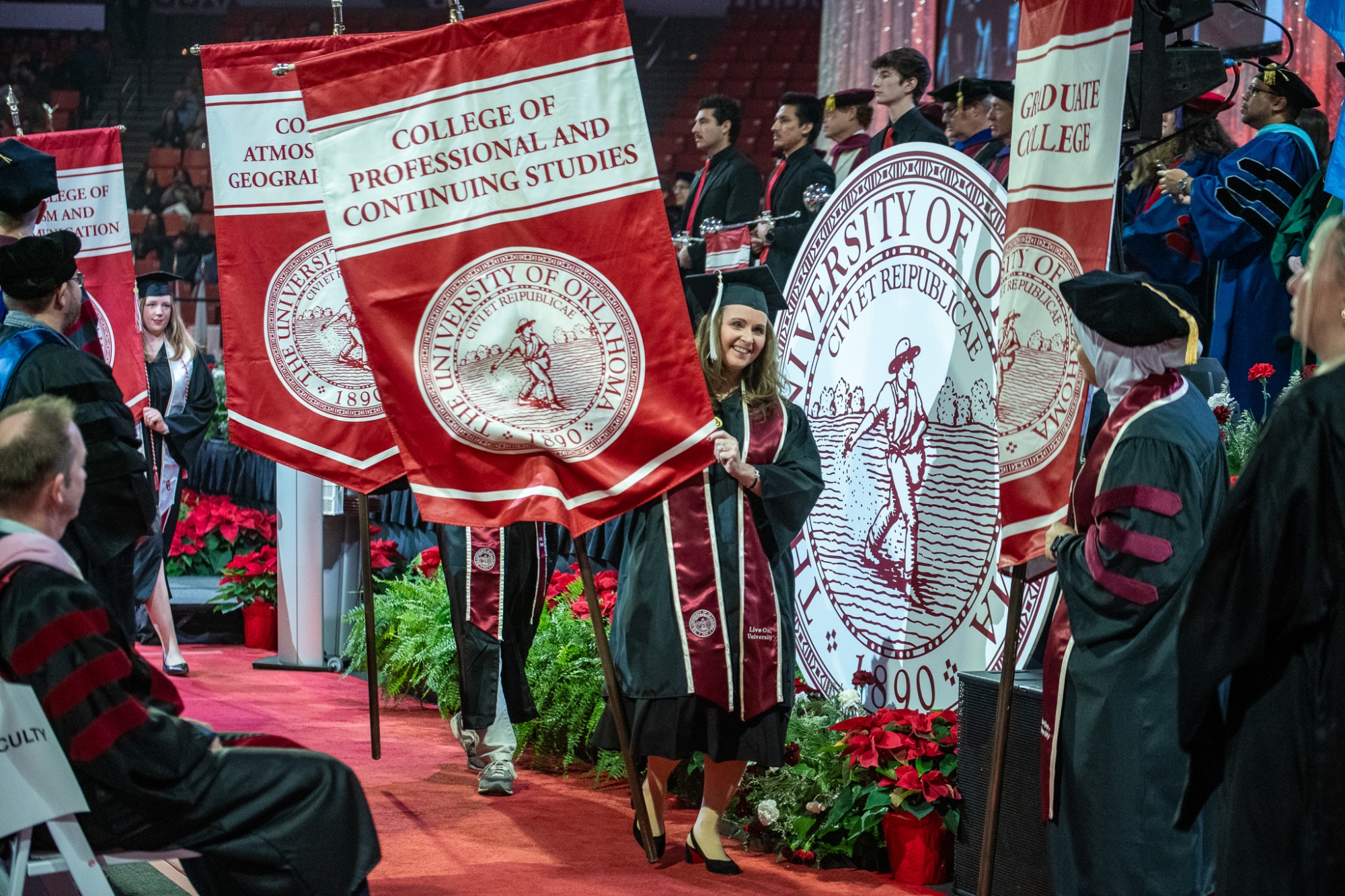 Students and faculty in regalia attend a commencement ceremony.