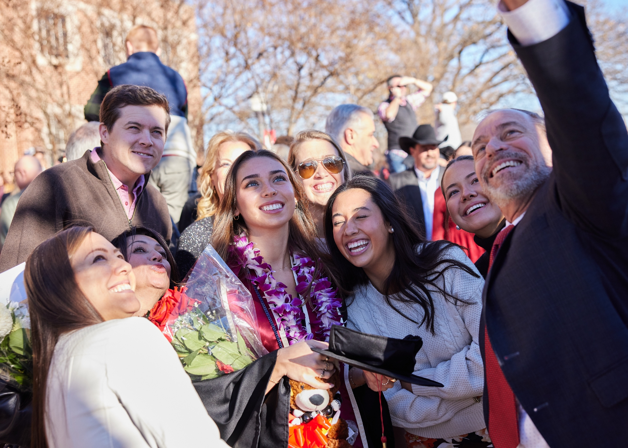 A family taking a selfie on campus with their OU grad.