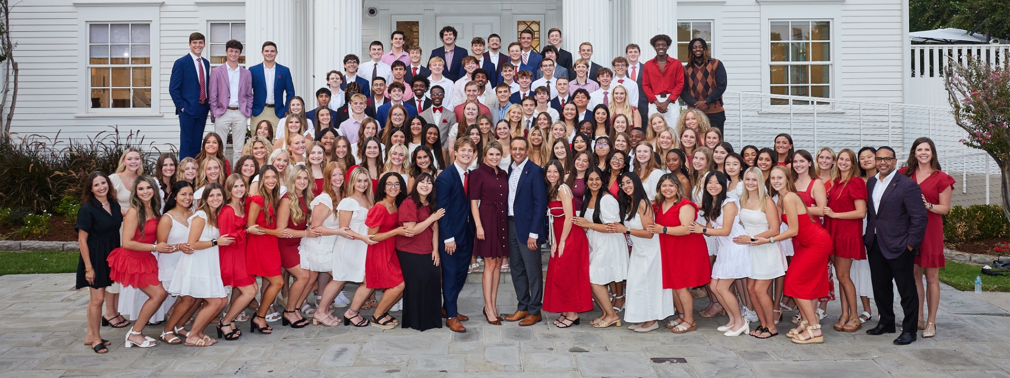 The President's Leadership Class 64 group photo in front of Boyd House. 