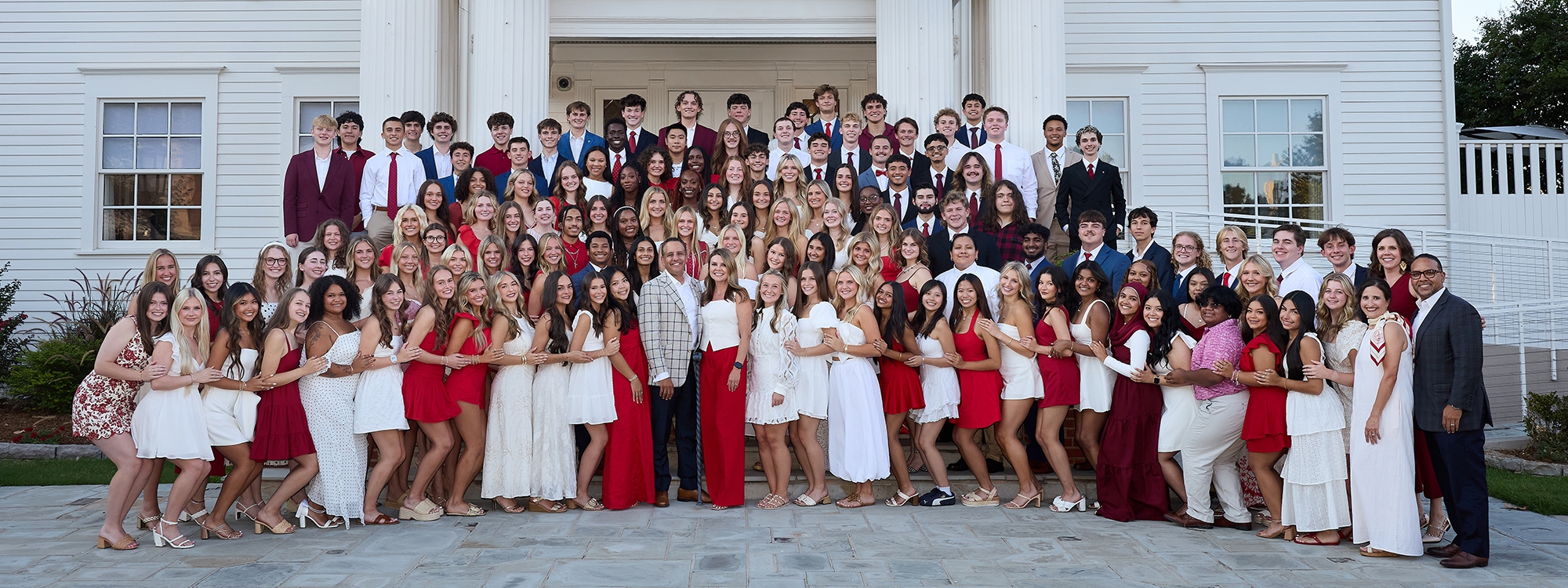 The President's Leadership Class 65 group photo in front of Boyd House. 