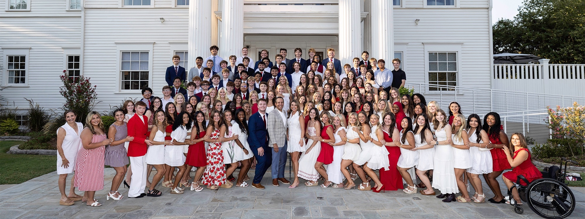 The President's Leadership Class 66 group photo in front of Boyd House. 