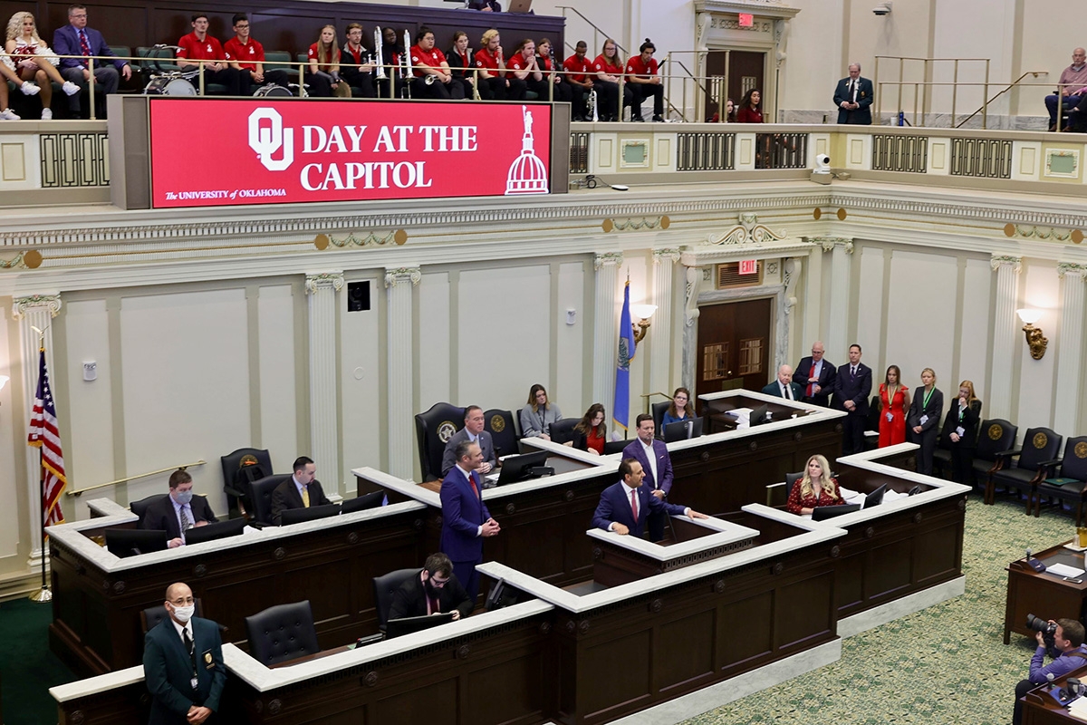 OU President Joe Harroz delivers remarks beneath an OU Day at the Capitol banner at the Oklahoma state capitol