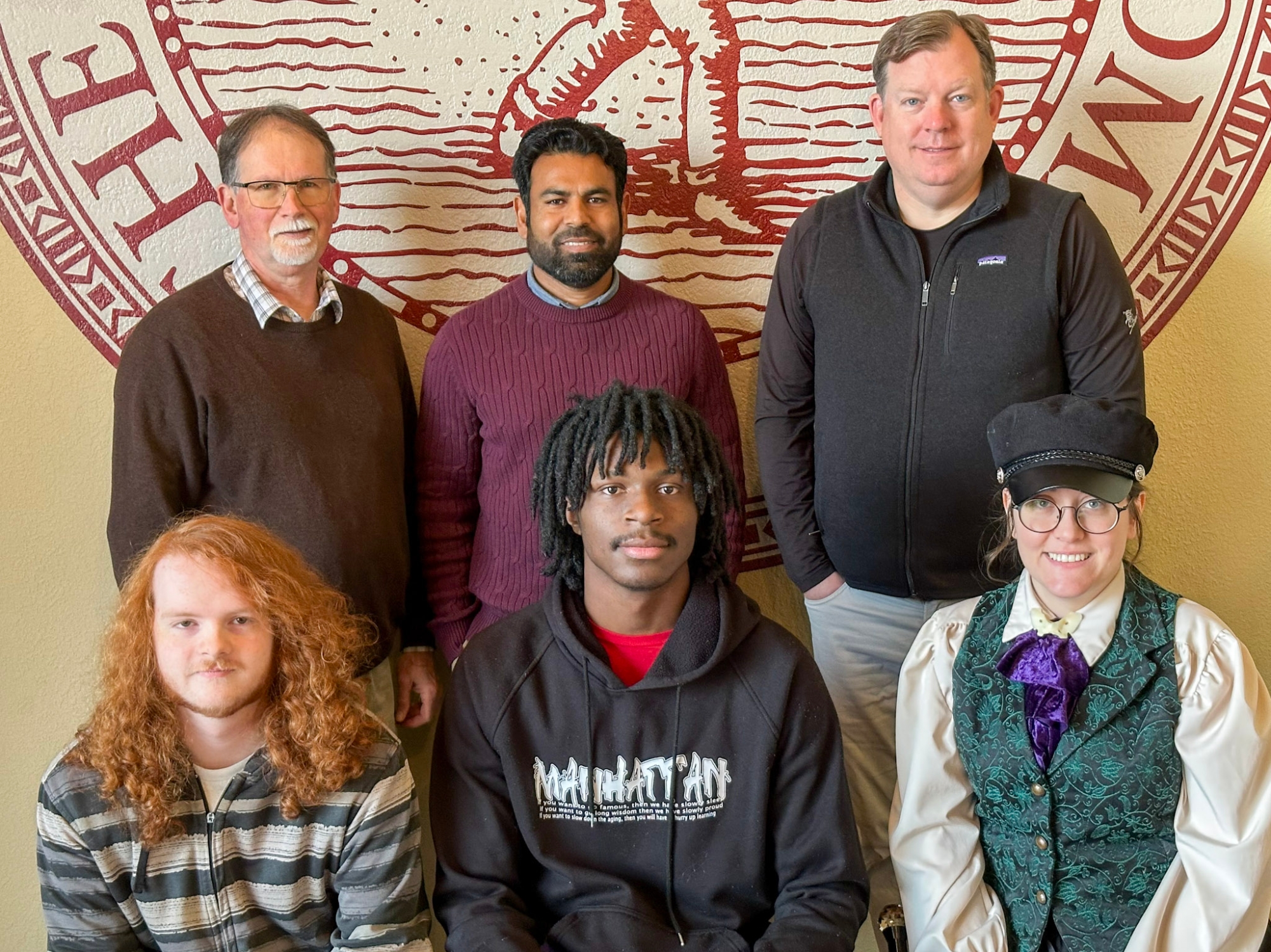 Three McNair scholars with their mentors standing together.