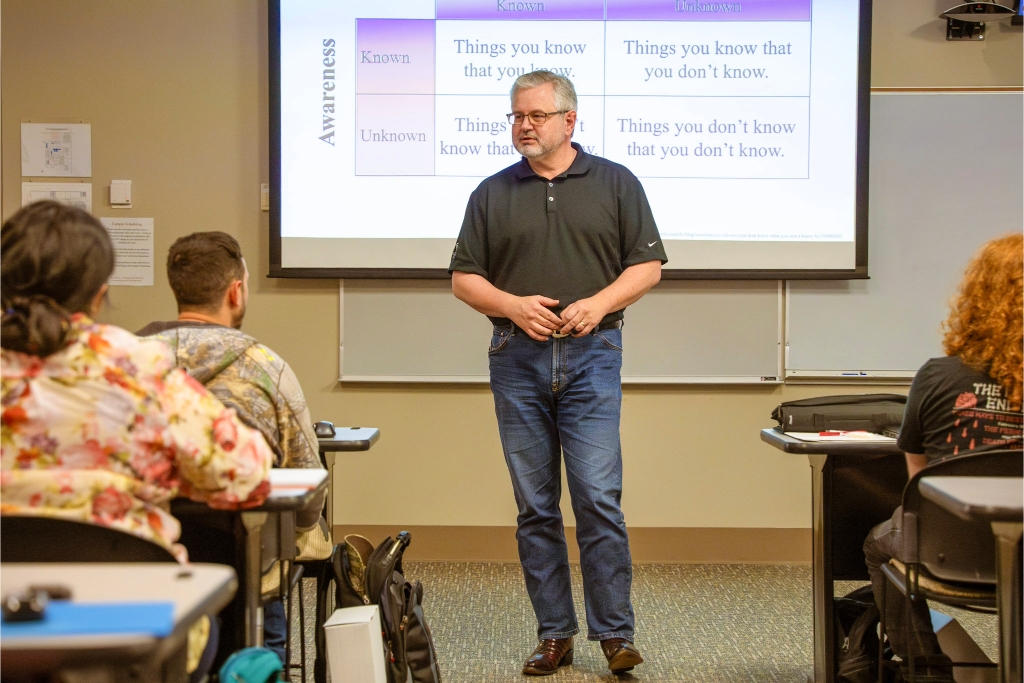 Dr. Freeze standing in front of a presentation.