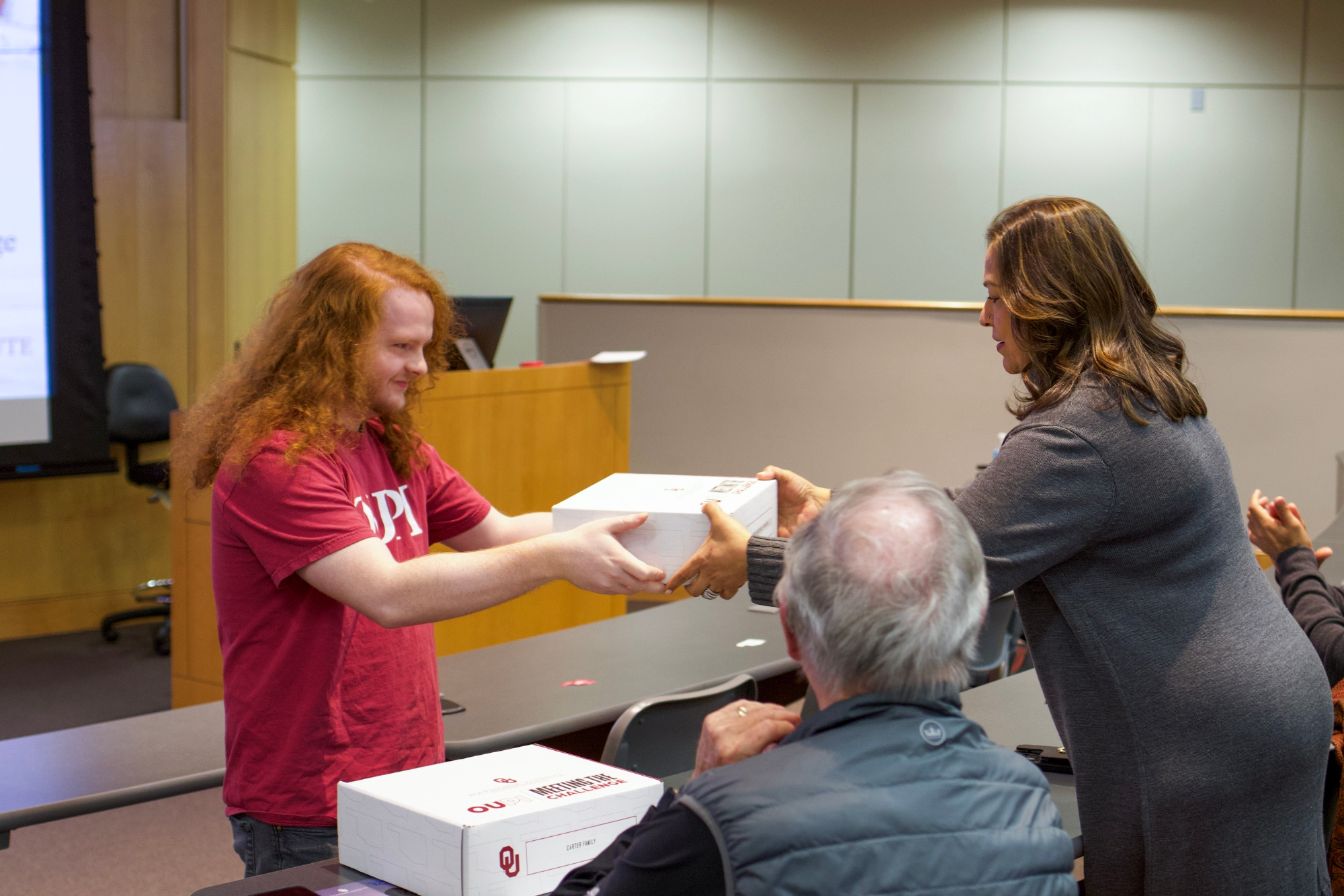 A student giving a thank present to a donor.