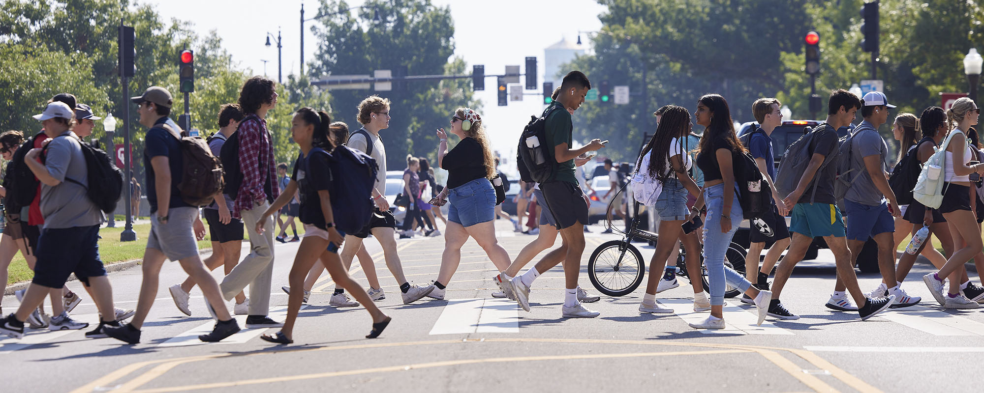 students on campus crossing the street between classes.