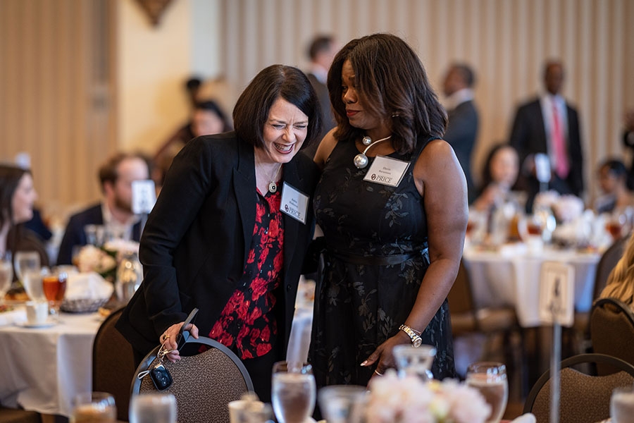 Two alumni talking and laughing during a special Price alumni event.