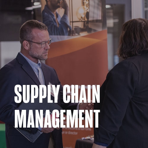 Two people engaged in a conversation. Text over photo reads: Supply Chain Management