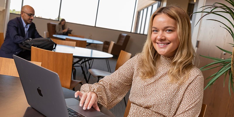 A young woman working on a laptop.