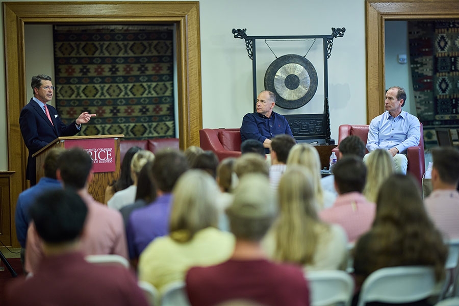 A large group of students listen to Director Mike McConnell introduce guest speakers at a special event for Energy Managment Students.