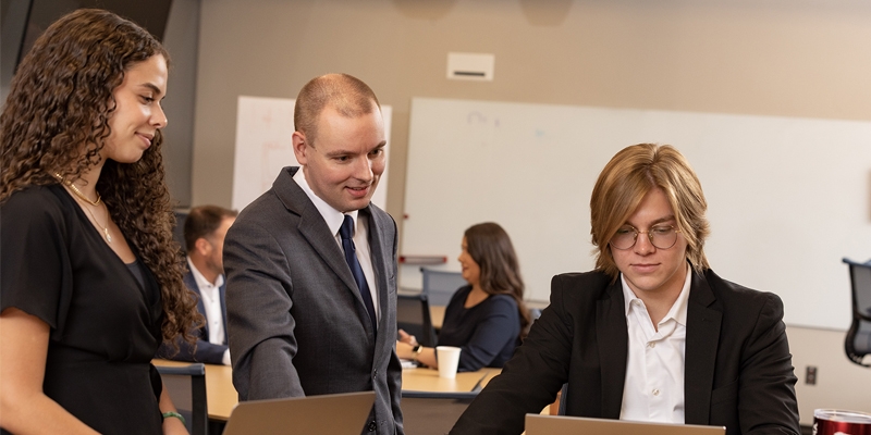 Professor works with two MBA students at a classroom at the graduate center near downtown Oklahoma City, OK