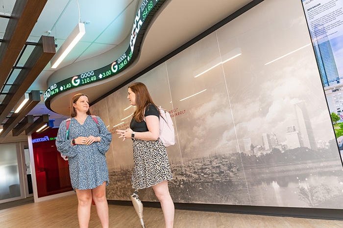 two MBA students converse in the hallway of the graduate center in downtown Oklahoma City