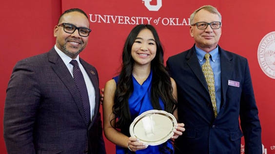 Kayla Nguyen with Dean of Students David Surratt (left) and SOA faculty member Joe Dulin (right) at the campus-wide ceremony in November to recognize recipients. 