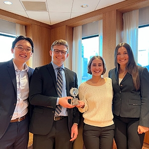 Student team members Alan Tran, from left, Taylor Smail, Gracie Silver and Jules Fisher stand with their award at the CUIBE International Strategy Case Competition on April 1, 2023
