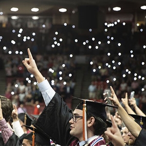 a group of students in their graduation regalia recite the OU chant at convocation