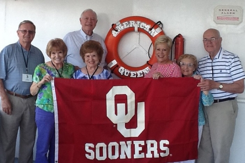 Elenor Smit Fox and friends hold up OU flag