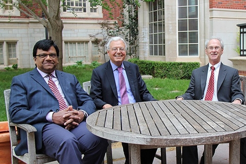 photo of Chitru Fernando, Louis Ederington, and Scott Linn sittin together in Dodson courtyard outside Adam's Hall on the OU Norman campus