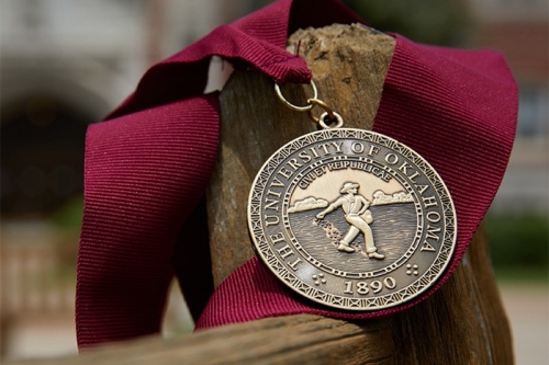 Photo of OU Medal which reads The University of Oklahoma 1890