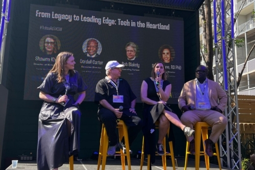 Rachel Lane sits on stage with additional panelists at SXSW