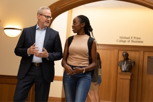 Dean Corey Phelps converses with a student as they walk through Price Hall