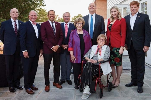Alumni from Price College of Business pose for a group photo with OU president Joseph Harroz. Pictured with Harroz are Carl Anderson III, Phillip and Nancy Estes, William and Amy Paiva
