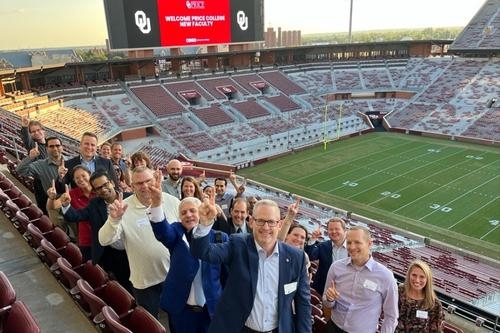 Dean Corey Phelps with the new faculty group at the OU Memorial stadium