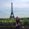 Student posing for a photo in front of the Eifel Tower while in Paris France
